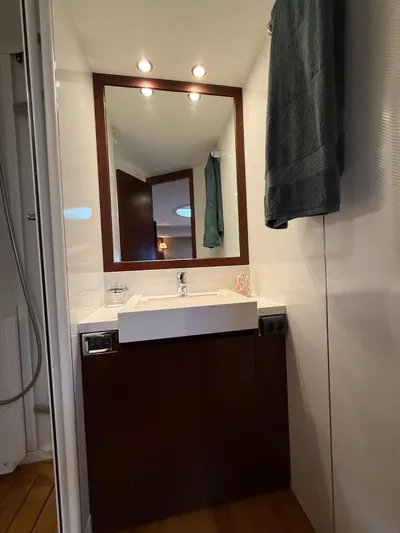  Yacht Photos Pics Luxurious bathroom interior of 2009 Princess V65 yacht with modern sink and mirror.