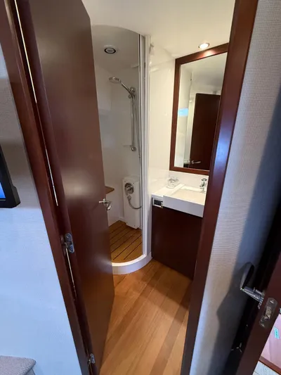  Yacht Photos Pics Luxurious bathroom interior of 2009 Princess V65 yacht with shower and wooden flooring.