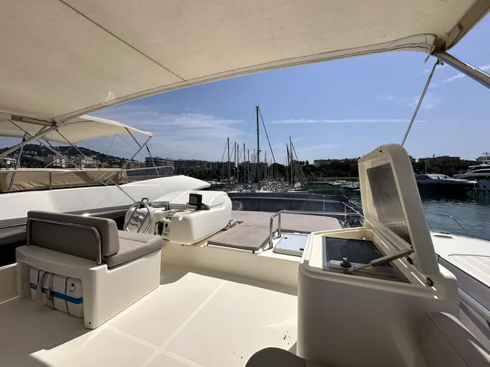  Yacht Photos Pics Flybridge of 2011 Ferretti Yachts 530 with marina view, featuring helm and seating area.