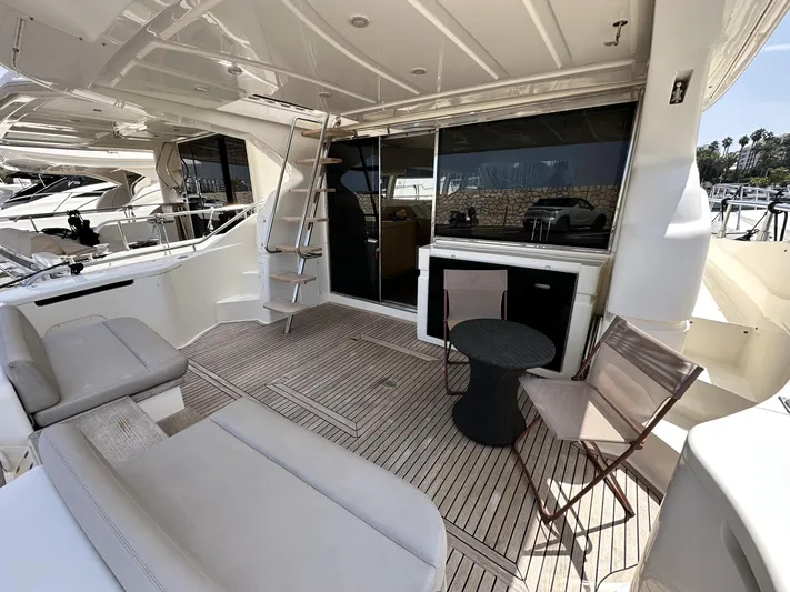  Yacht Photos Pics Luxurious 2011 Ferretti Yachts 530 deck with seating, table, and ladder.