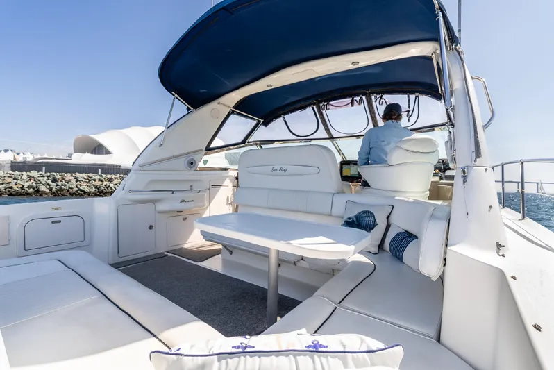 "carried Aweigh" Yacht Photos Pics 1999 Sea Ray 400 Sundancer yacht interior with seating, table, and blue canopy.