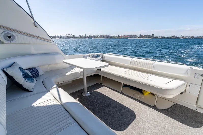 "carried Aweigh" Yacht Photos Pics 1999 Sea Ray 400 Sundancer yacht interior with seating and table, overlooking the ocean.