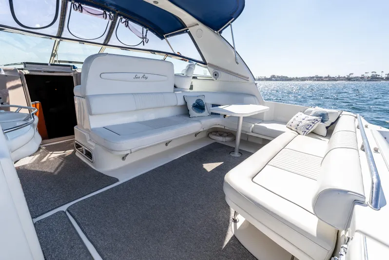 "carried Aweigh" Yacht Photos Pics 1999 Sea Ray 400 Sundancer yacht interior with white seating, table, and ocean view.
