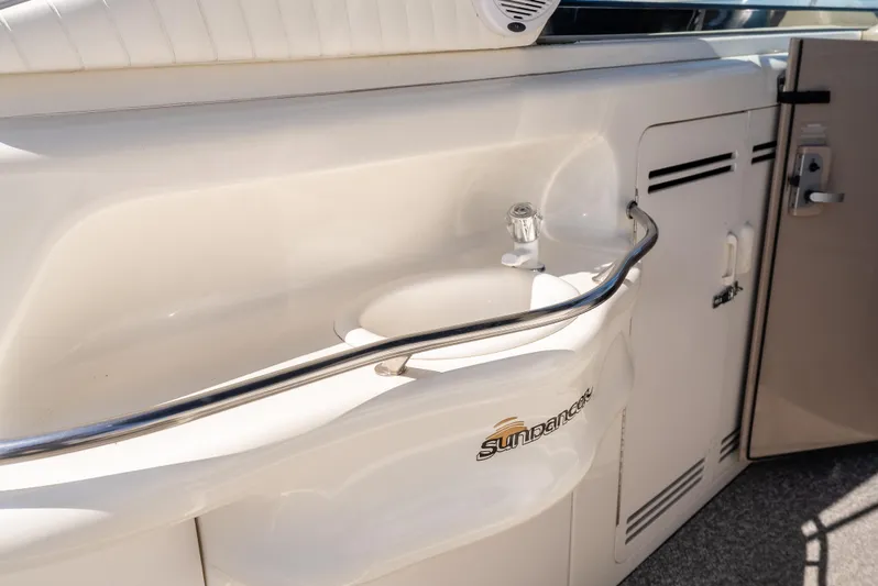 "carried Aweigh" Yacht Photos Pics 1999 Sea Ray 400 Sundancer yacht interior with sink and storage cabinets.