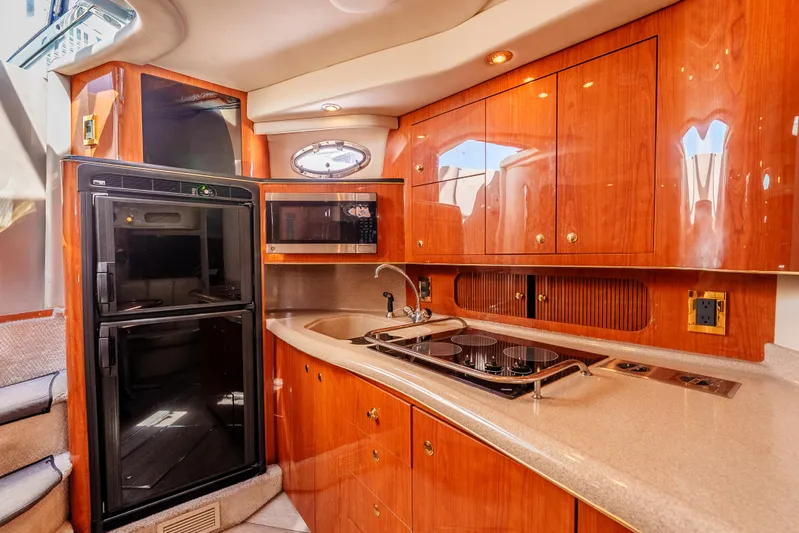 "carried Aweigh" Yacht Photos Pics Luxurious 1999 Sea Ray 400 Sundancer yacht kitchen with wood cabinetry and modern appliances.