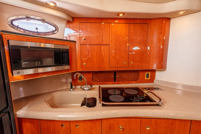"carried Aweigh" Yacht Photos Pics Luxurious kitchen area in a 1999 Sea Ray 400 Sundancer yacht with wood cabinetry.