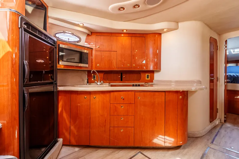"carried Aweigh" Yacht Photos Pics Luxurious 1999 Sea Ray 400 Sundancer yacht interior with wooden cabinetry and modern kitchen amenities.