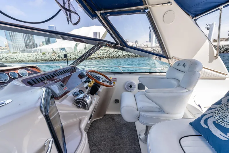 "carried Aweigh" Yacht Photos Pics 1999 Sea Ray 400 Sundancer helm with luxurious seating and waterfront view.