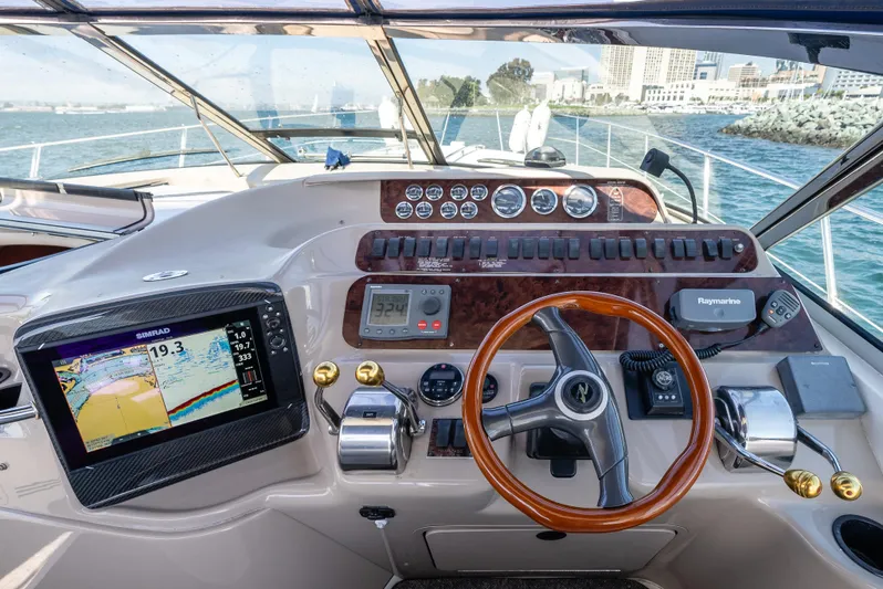 "carried Aweigh" Yacht Photos Pics Helm of 1999 Sea Ray 400 Sundancer with navigation equipment and steering wheel.