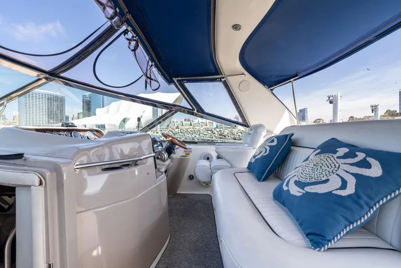 "carried Aweigh" Yacht Photos Pics Interior of 1999 Sea Ray 400 Sundancer yacht with blue cushions and city skyline view.