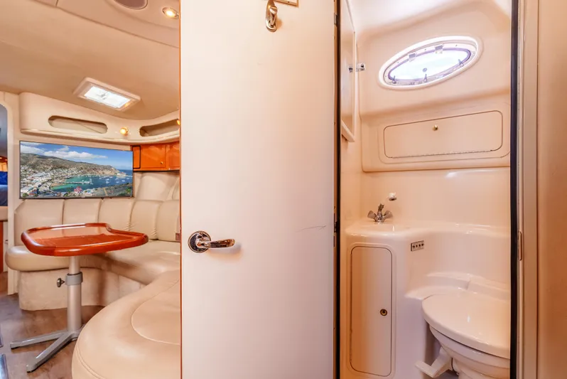 "carried Aweigh" Yacht Photos Pics Interior of 1999 Sea Ray 400 Sundancer yacht, featuring a cozy seating area and compact bathroom.