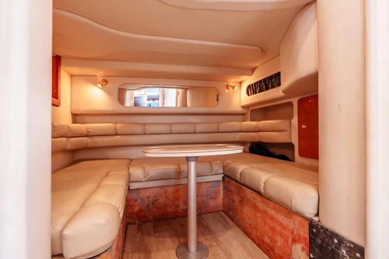 "carried Aweigh" Yacht Photos Pics Interior of 1999 Sea Ray 400 Sundancer yacht with beige seating and table.