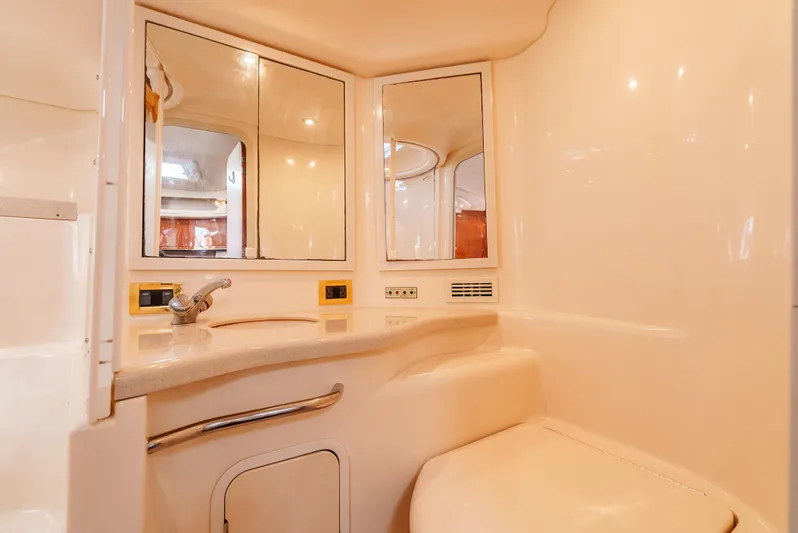 "carried Aweigh" Yacht Photos Pics 1999 Sea Ray 400 Sundancer bathroom with mirrors, sink, and beige interior.