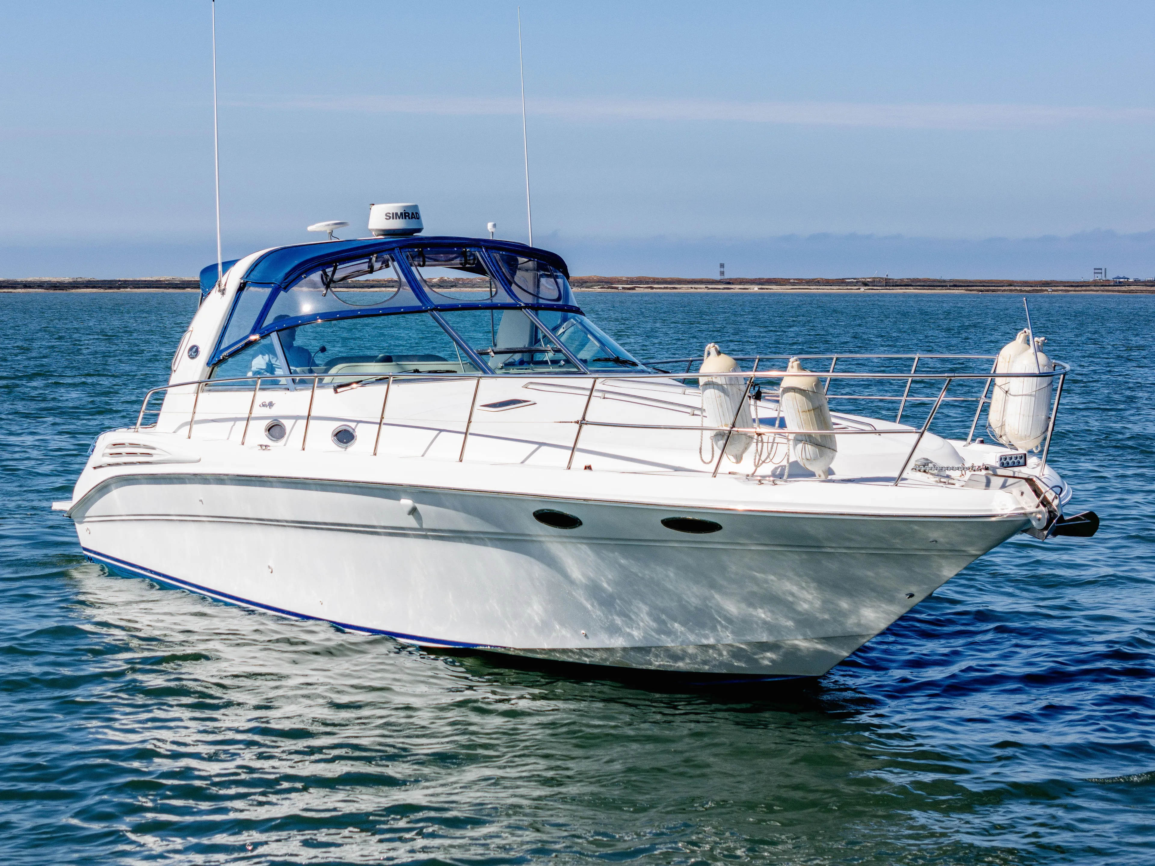 "carried Aweigh" Yacht Photos Pics 1999 Sea Ray 400 Sundancer yacht on calm water, featuring sleek design and blue accents.