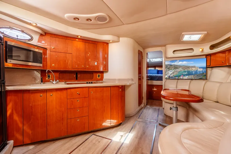 "carried Aweigh" Yacht Photos Pics Luxurious interior of 1999 Sea Ray 400 Sundancer yacht with wood cabinetry and plush seating.