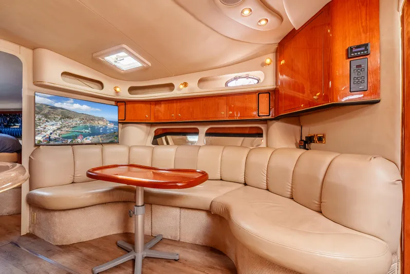 "carried Aweigh" Yacht Photos Pics Luxurious interior of 1999 Sea Ray 400 Sundancer yacht with plush seating and wooden cabinetry.