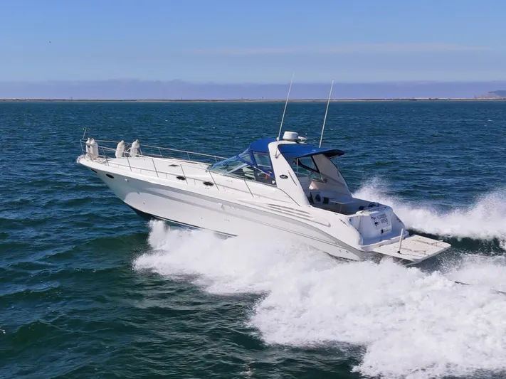 "carried Aweigh" Yacht Photos Pics 1999 Sea Ray 400 Sundancer cruising on open water, showcasing sleek design and performance.
