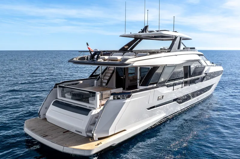 Together Yacht Photos Pics 2025 Ferretti Yachts 940 cruising on open sea under clear blue sky.