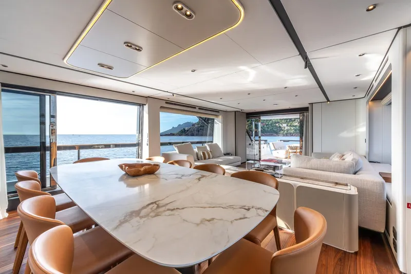 Together Yacht Photos Pics Luxurious interior of 2025 Ferretti Yachts 940 with elegant dining and lounge area.