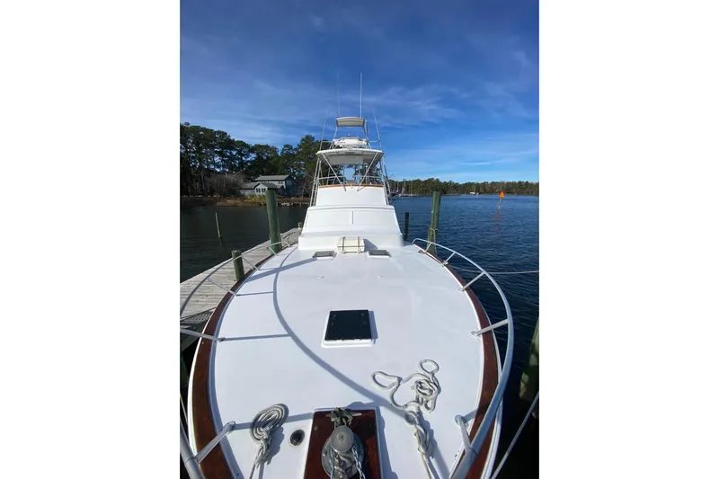 Second Chance Yacht Photos Pics 1986 Post 46 yacht docked on a serene lake under a clear blue sky.
