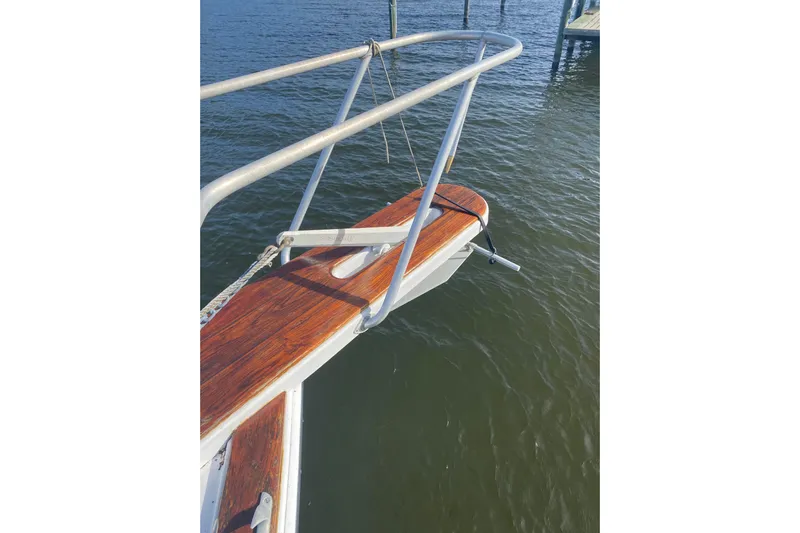 Second Chance Yacht Photos Pics Bow of 1986 Post 46 boat with wooden deck and metal railings over water.