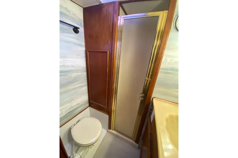 Second Chance Yacht Photos Pics Compact 1986 Post 46 yacht bathroom with shower, toilet, and wooden accents.