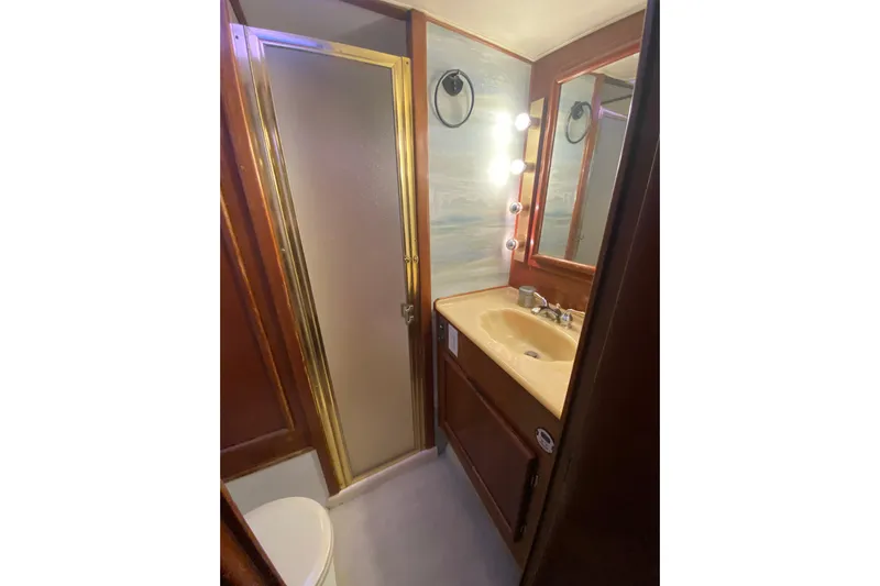Second Chance Yacht Photos Pics Compact 1986 Post 46 yacht bathroom with shower, vanity, and mirror lighting.