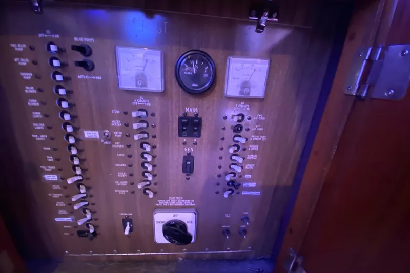 Second Chance Yacht Photos Pics Electrical control panel with switches and gauges, Post 46 model, 1986, illuminated in blue light.