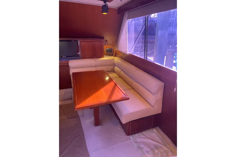 Second Chance Yacht Photos Pics Interior of 1986 Post 46 yacht with beige seating and wooden table.