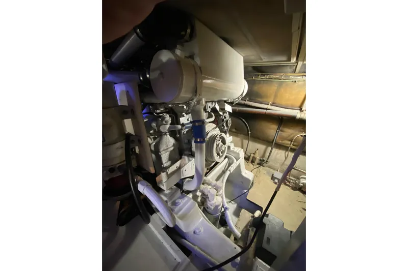 Second Chance Yacht Photos Pics Engine compartment of a 1986 Post 46 boat, showcasing mechanical components and piping.