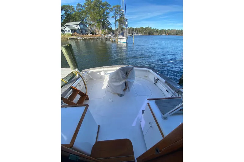 Second Chance Yacht Photos Pics 1986 Post 46 boat deck with scenic waterfront view and docked sailboats.