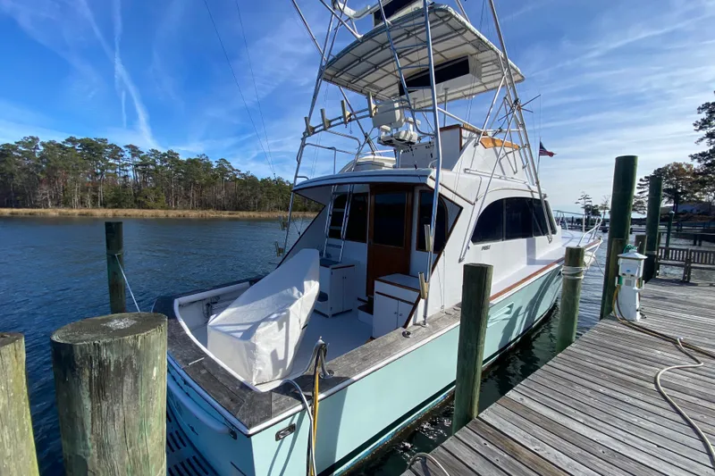 Second Chance Yacht Photos Pics 1986 Post 46 yacht docked by a wooden pier under a clear blue sky.
