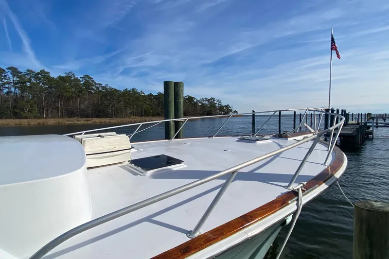 Second Chance Yacht Photos Pics 1986 Post 46 yacht docked by serene waters, American flag waving.