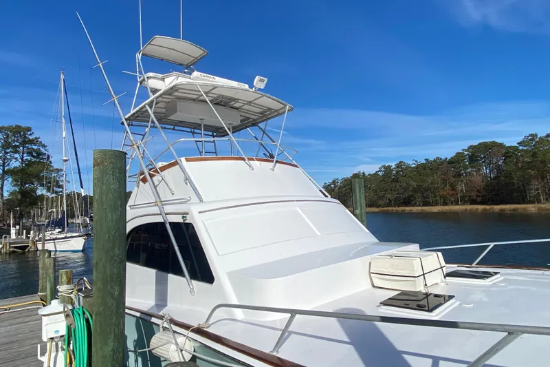 Second Chance Yacht Photos Pics 1986 Post 46 yacht docked by serene waters under clear blue sky.
