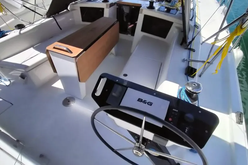  Yacht Photos Pics 2025 Dufour 41 yacht cockpit with steering wheel and seating area.
