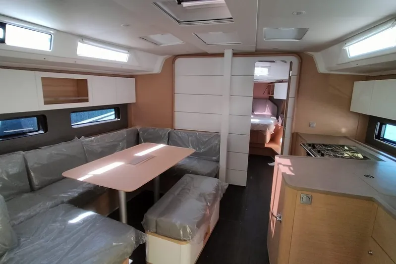  Yacht Photos Pics Modern interior of 2025 Dufour 41 yacht with dining area and kitchen.