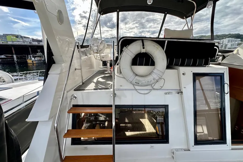 Rover Yacht Photos Pics 1993 Ocean Alexander 460 yacht with wooden steps and life preserver, docked at marina.