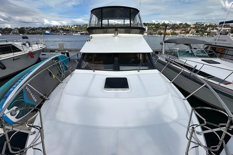 Rover Yacht Photos Pics 1993 Ocean Alexander 460 yacht docked with paddleboard, scenic waterfront view.