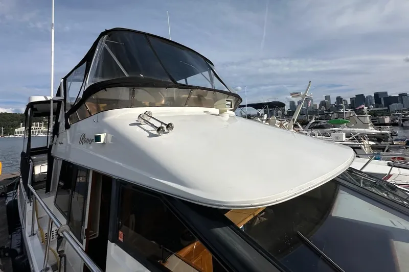 Rover Yacht Photos Pics 1993 Ocean Alexander 460 yacht docked with city skyline in background.