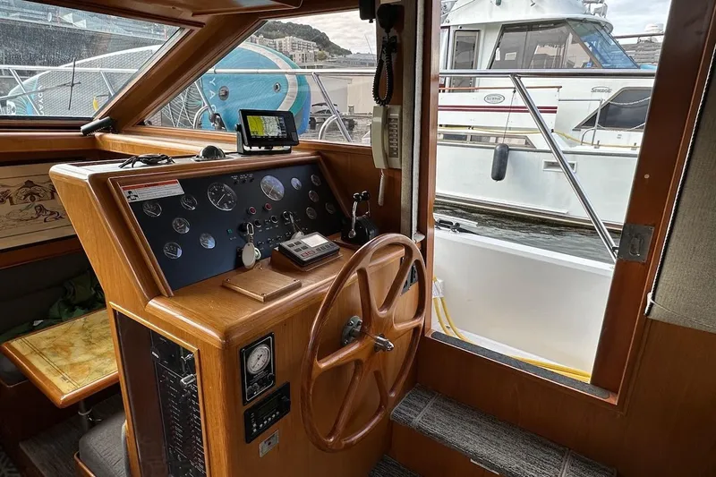 Rover Yacht Photos Pics Interior helm of 1993 Ocean Alexander 460 yacht with wooden steering wheel and control panel.