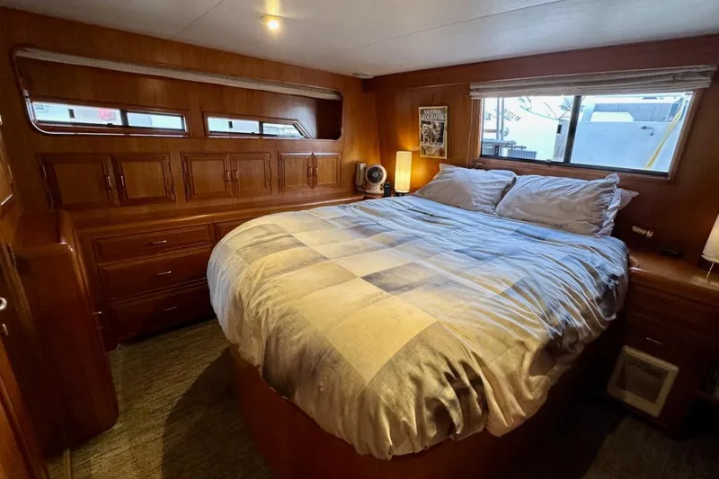 Rover Yacht Photos Pics Cozy bedroom in 1993 Ocean Alexander 460 yacht with wood paneling and large bed.