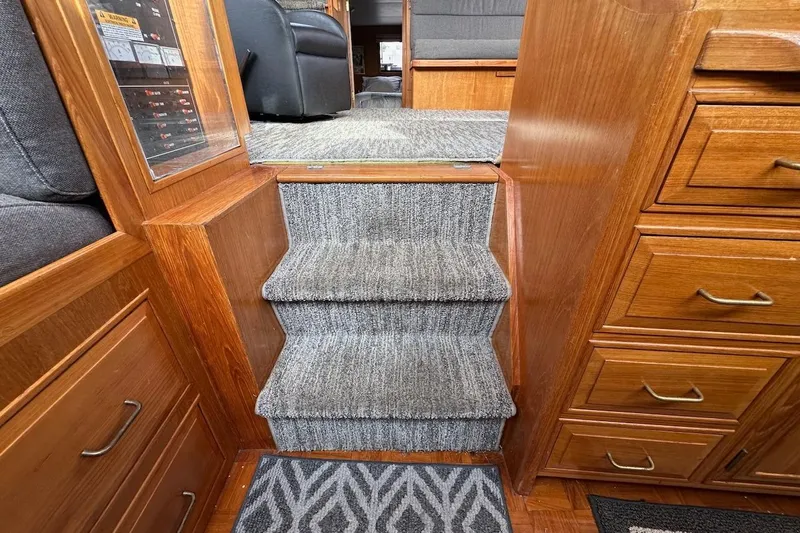 Rover Yacht Photos Pics Interior of 1993 Ocean Alexander 460 yacht with carpeted stairs and wooden cabinetry.