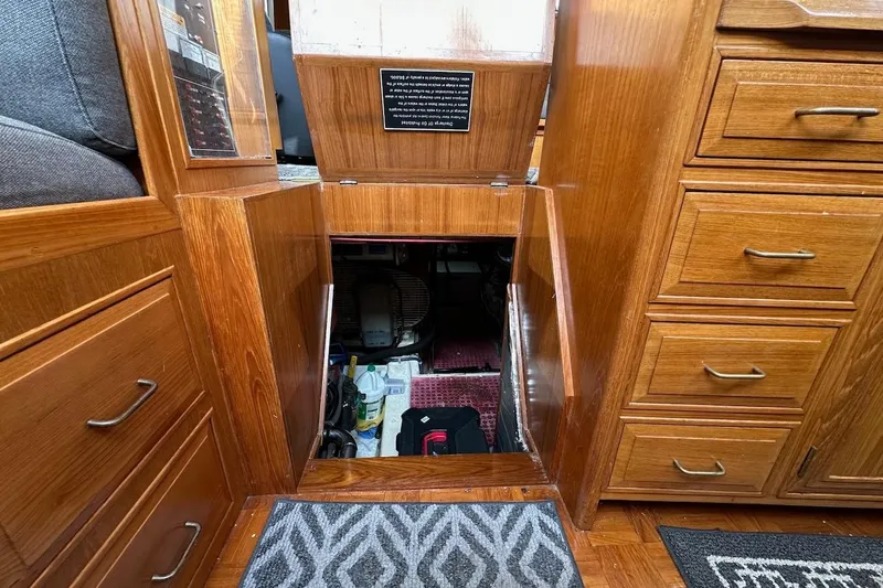 Rover Yacht Photos Pics Engine compartment access in 1993 Ocean Alexander 460 yacht, featuring wooden cabinetry and storage drawers.