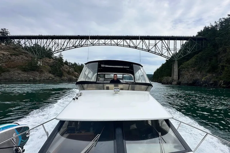 Rover Yacht Photos Pics Ocean Alexander 460 yacht cruising under a scenic bridge, surrounded by lush greenery, 1993 model.