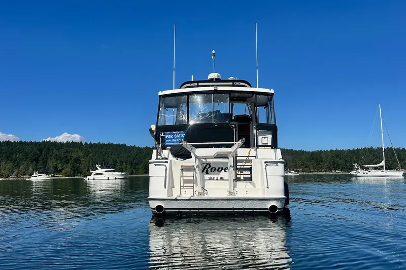 Rover Yacht Photos Pics Ocean Alexander 460 yacht from 1993, anchored on a sunny day, with "For Sale" sign.