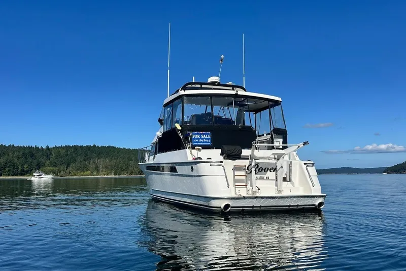 Rover Yacht Photos Pics Ocean Alexander 460 yacht from 1993 on calm water, clear blue sky background.