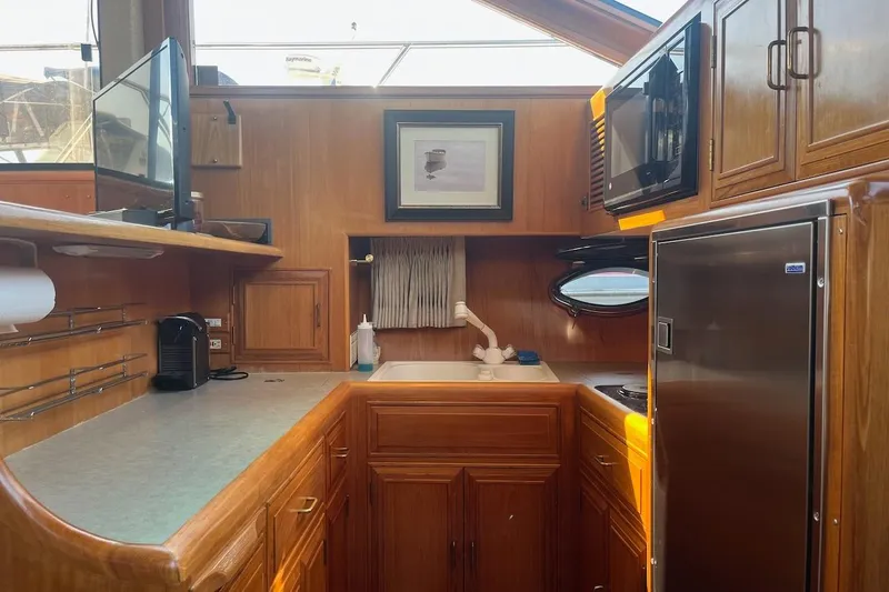 Rover Yacht Photos Pics Cozy kitchen in 1993 Ocean Alexander 460 yacht with wood cabinetry and modern appliances.