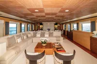 Luxurious yacht interior with elegant seating, wooden accents, and ocean views, ISA Custom 2012 model.