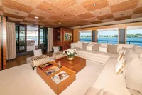 Luxurious yacht interior with elegant seating, wooden accents, and ocean view, ISA Custom 2012 model.