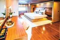 Luxurious yacht bedroom with wooden decor, large bed, and elegant furnishings, ISA Custom 2012 model.